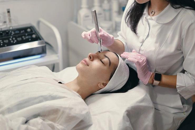 A lady is undergoing laser cosmetic treatment