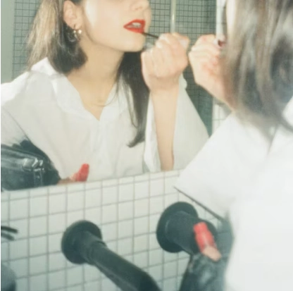 a woman in front of a mirror