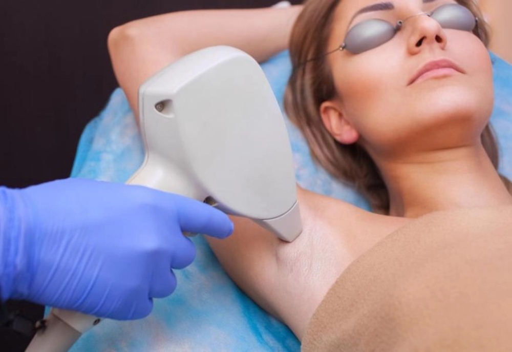 woman removing hair under their arms